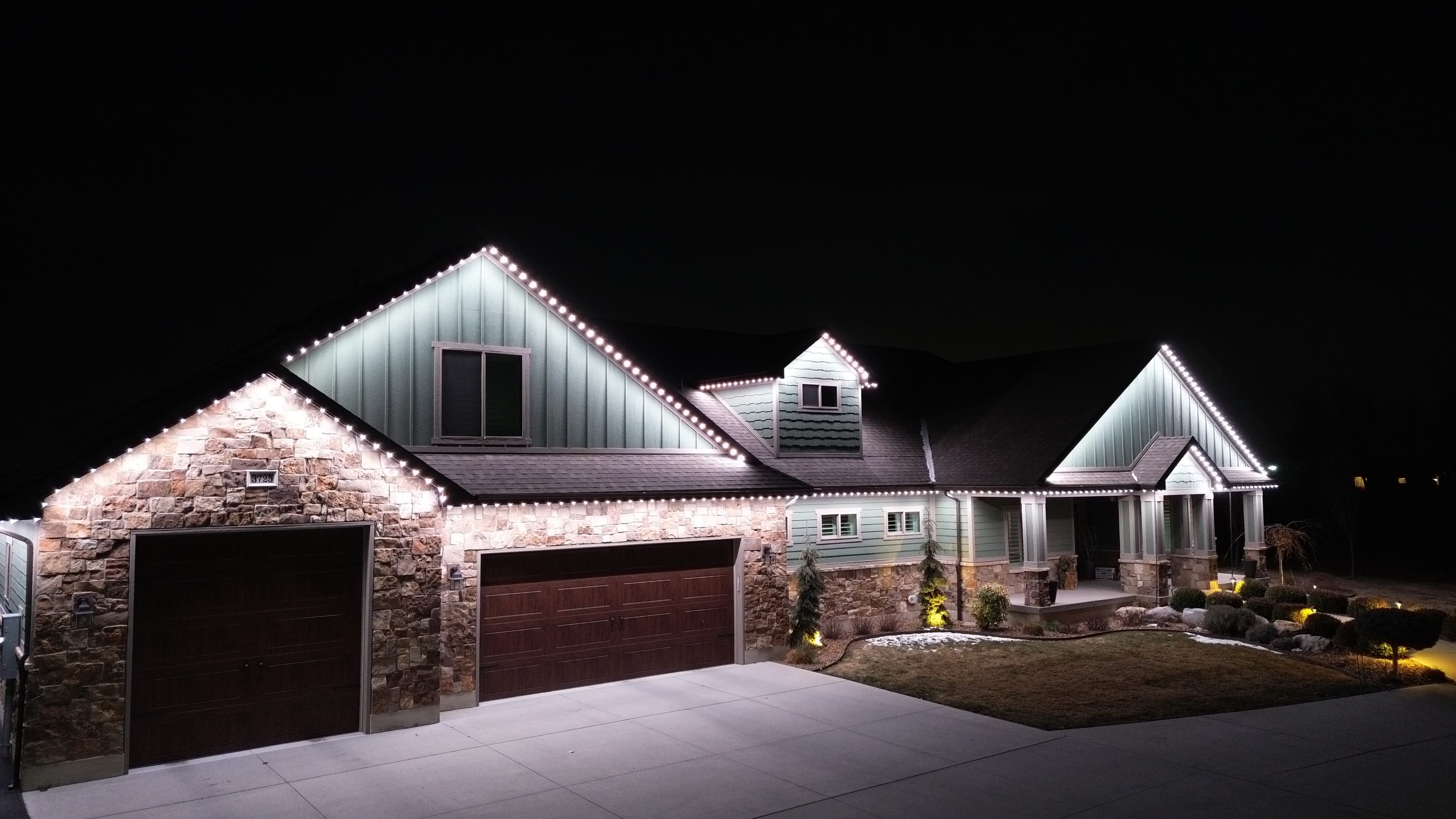 Security lighting on a home at night, a TruLight network installation